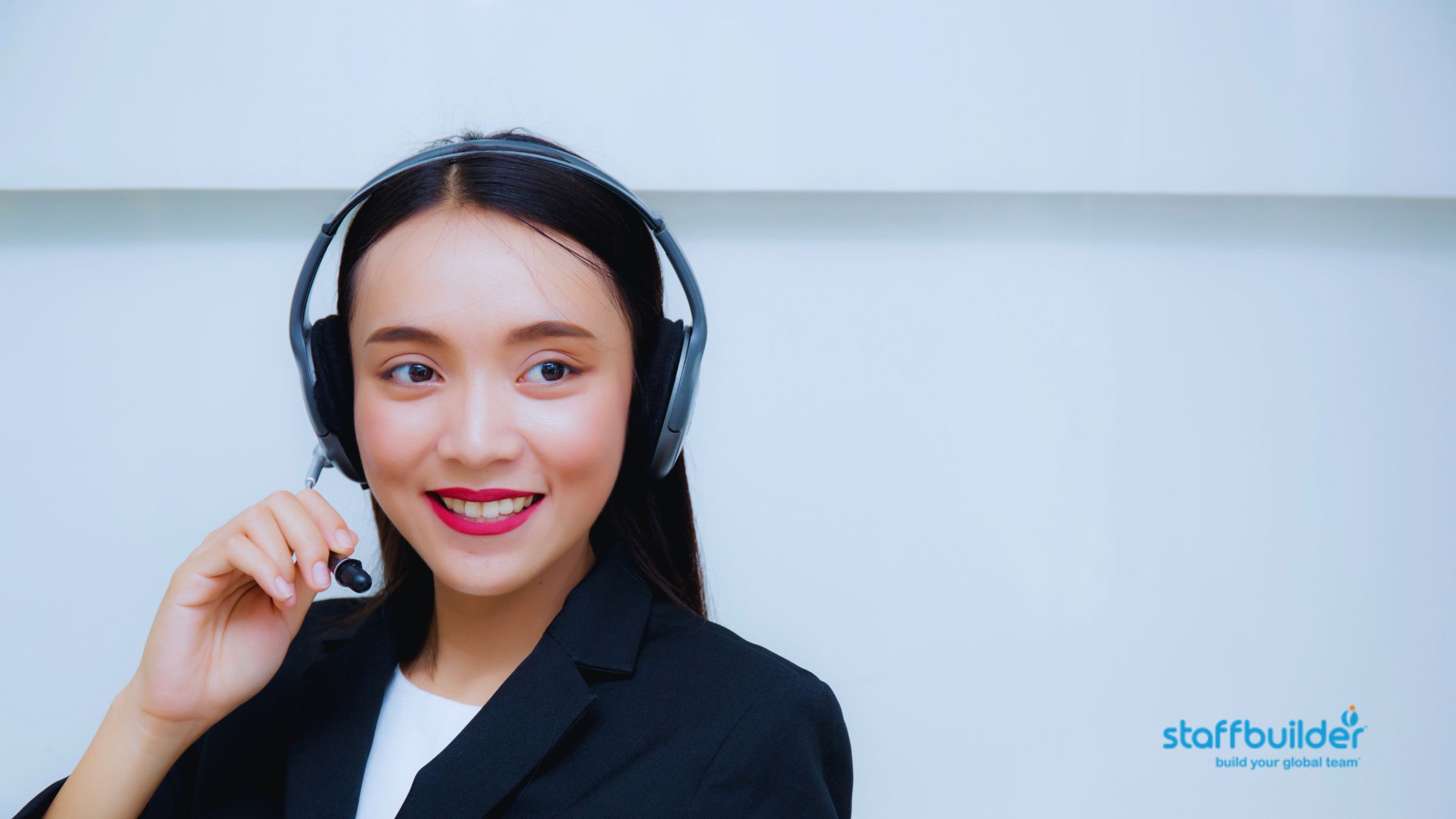 a filipino employee is working and talking with headphone equipment